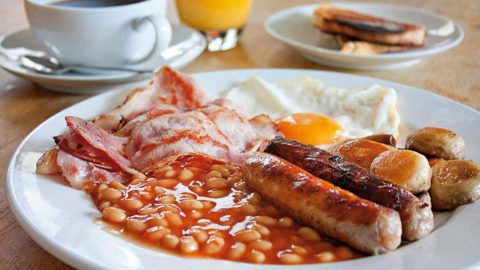 Photo of a A delicious Combe breakfast, including bacon, eggs, sausages and baked beans